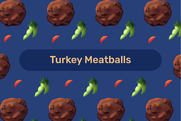 Turkey meatballs with peas and red peppers arranged on a blue background.